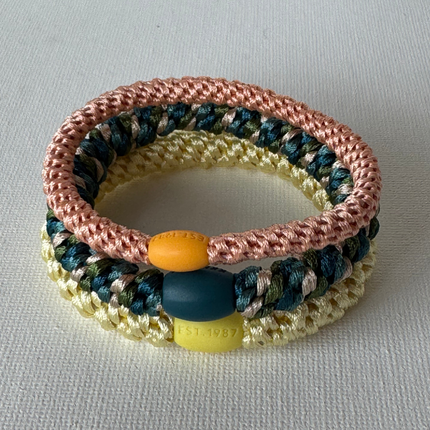 Three KKNEKKI woven hair ties together