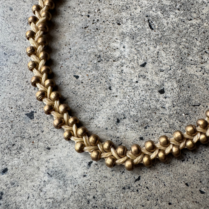 Close-up of the brass beads on the Nav Macrame Bracelet