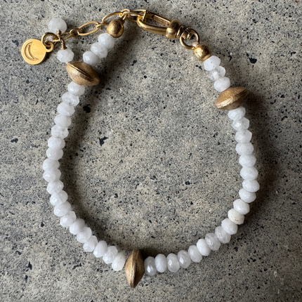 Cyrus White Onyx Bracelet with brass bead details, laid flat