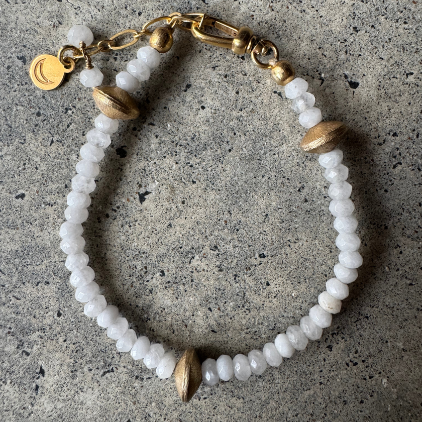 Cyrus White Onyx Bracelet with brass bead details, laid flat