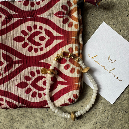Cyrus White Onyx Bracelet with a Chandra Collection pouch and card