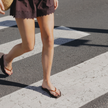 Walking across a street in Espresso Jelly Tapered Platform flip flops by Sandos