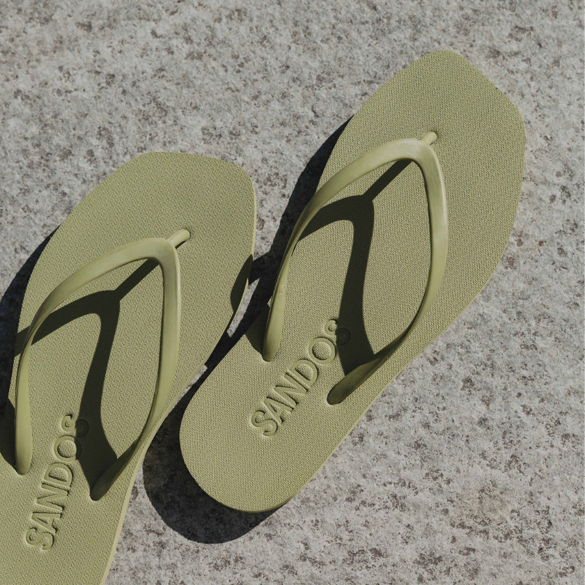 Pair of soft green Matcha Square flip flops by Sandos, top-down view