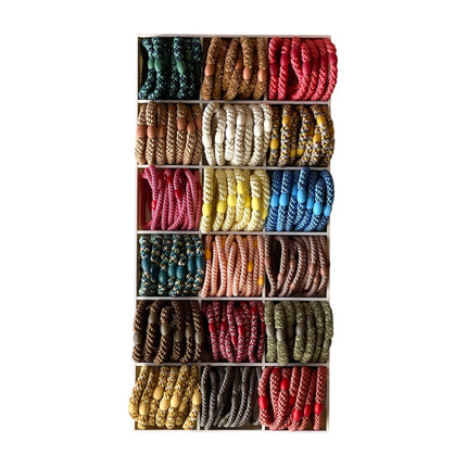 Display of KKNEKKI woven hair ties in a range of colours