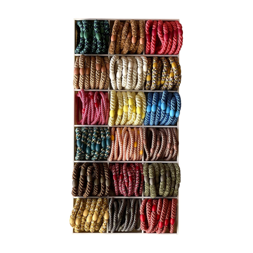 Display of KKNEKKI woven hair ties in a range of colours